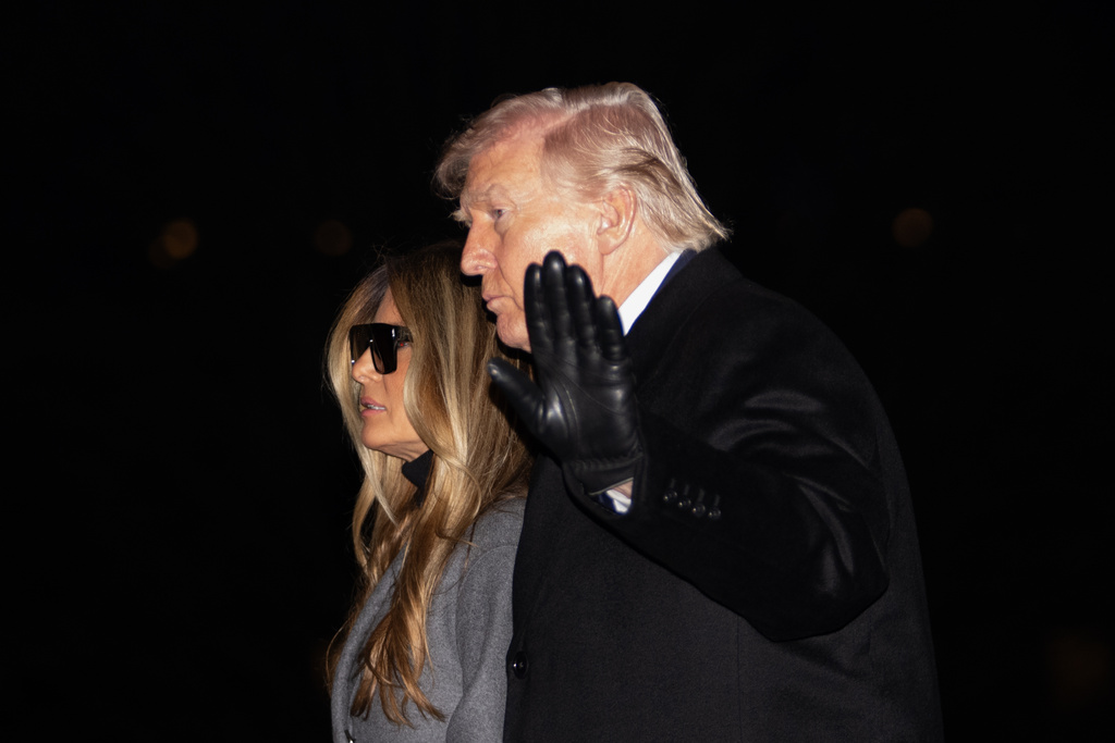 President Donald Trump and first lady Melania Trump walk on the South Lawn to the White House after arriving on Marine One Monday evening, Feb. 16, 2026, in Washington. (AP Photo/Allison Robbert)