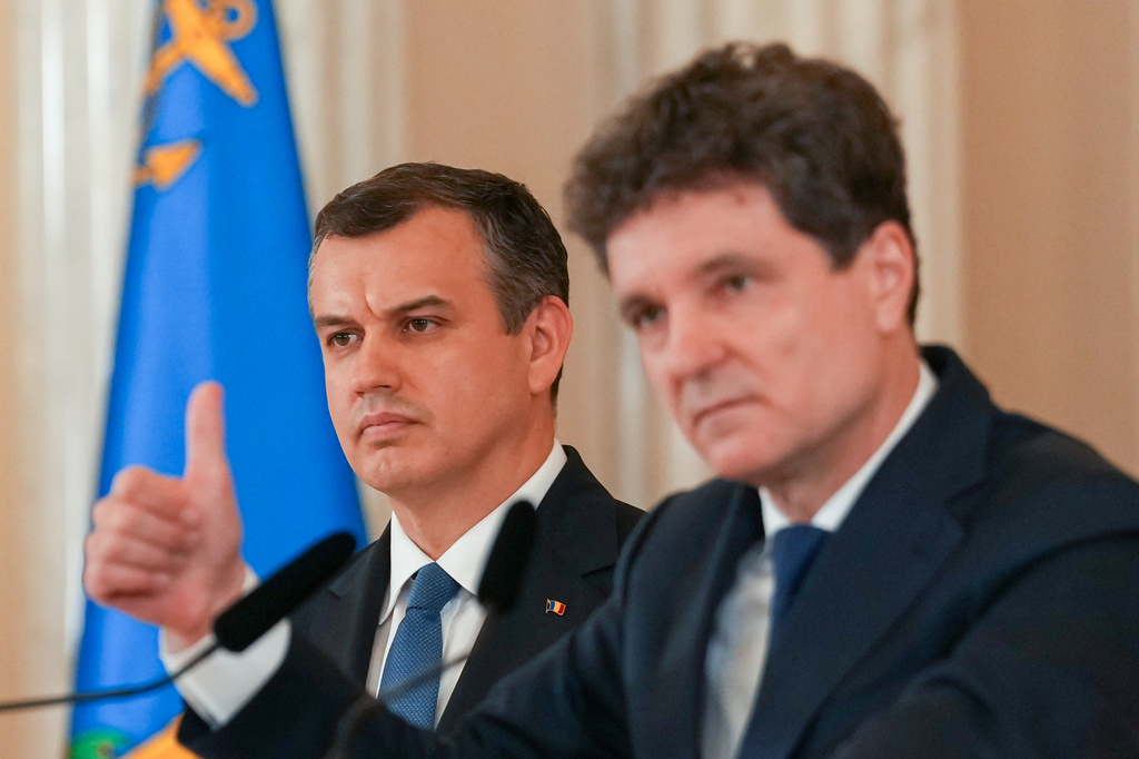 Prime Minister designate Eugen Tomac, left, listens to Romanian President Nicusor Dan during press statements at the Cotroceni Presidential Palace in Bucharest, Romania, Thursday, June 4, 2026. (AP Photo/Vadim Ghirda)