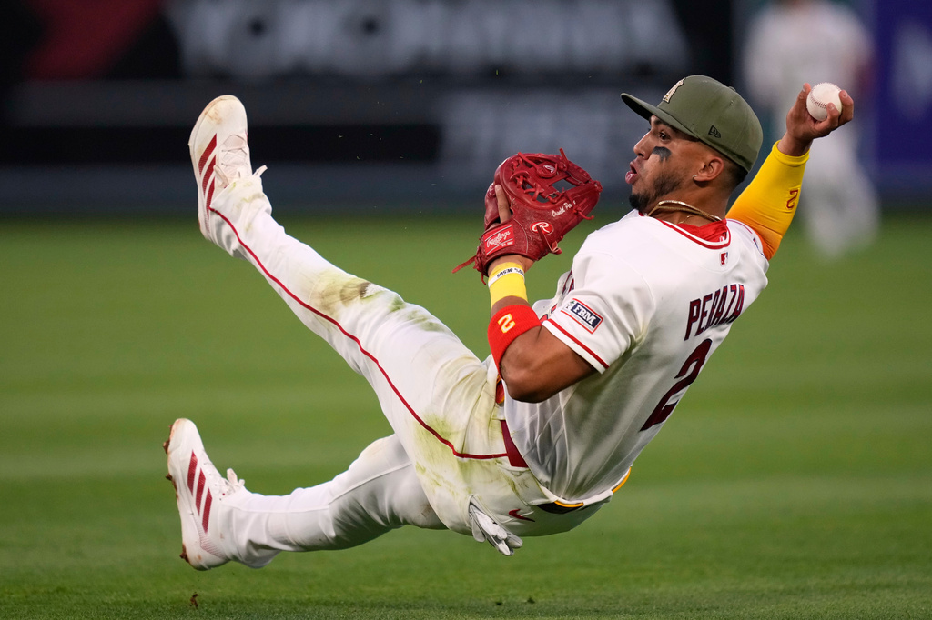 Los Angeles Angels second baseman Oswald Peraza throws out Los Angeles Dodgers' Hyeseong Kim at first during the fourth inning of a baseball game Friday, May 15, 2026, in Anaheim, Calif. (AP Photo/Mark J. Terrill)