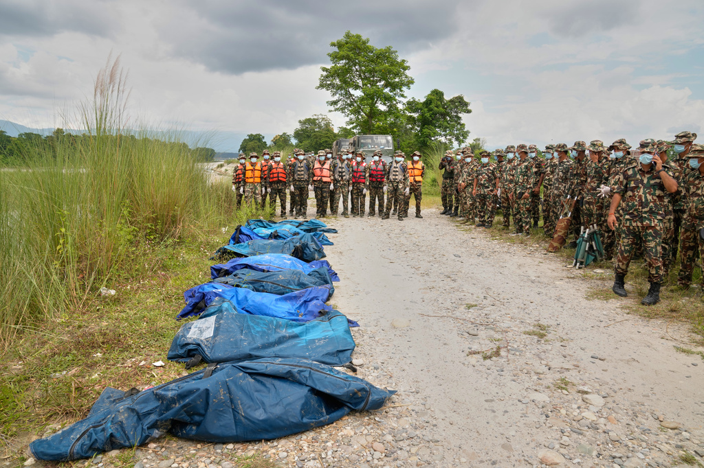 Nepalese army soldiers wait after recovering bodies of flash flood victims from a river in Chitwan, Nepal, Monday, Aug. 31, 2026. (AP Photo/Dar Yasin)