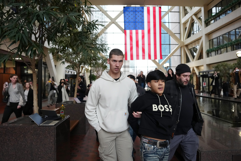 Plain clothed federal agents arrest a man after a short foot chase in the lobby of the Hennepin County Government Center in Minneapolis, on Tuesday, Feb. 10, 2026. (Anthony Souffle/Star Tribune via AP)