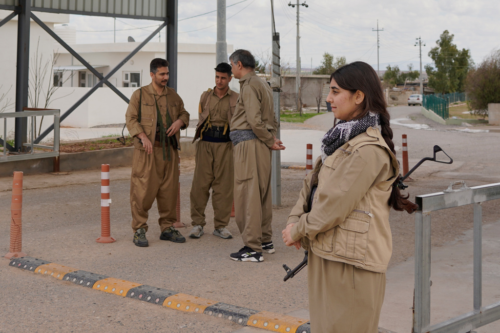 Members of the Democratic Party of Iranian Kurdistan PDKI stand at a checkpoint leading to their base in the Koya district of Irbil, Iraq, Friday, Feb. 27, 2026. (AP Photo/Rashid Yahya)