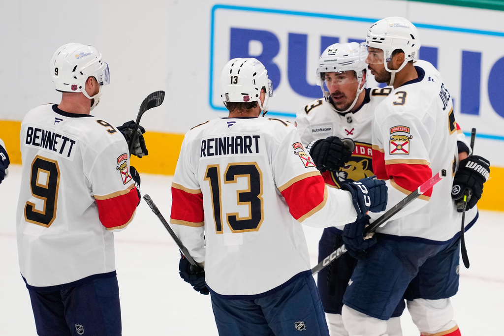 Florida Panthers' Sam Bennett (9), Sam Reinhart (13), Brad Marchand and Seth Jones (3) celebrate Marchand's goal against the Dallas Stars in the second period of an NHL hockey game in Dallas, Saturday, Dec. 13, 2025. (AP Photo/Tony Gutierrez)