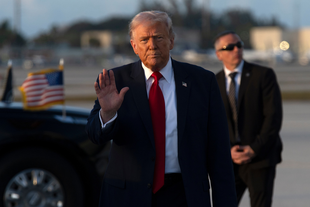 President Donald Trump gestures after stepping off Air Force One, Saturday, March 7, 2026, at Miami International Airport in Miami. (AP Photo/Mark Schiefelbein)