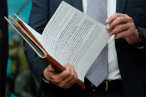 AstraZeneca CEO Pascal Soriot checks his notes before speaking at an event President Donald Trump in the Oval Office of the White House, Friday, Oct. 10, 2025, in Washington. (AP Photo/Alex Brandon) AstraZeneca CEO Pascal Soriot checks his notes before speaking at an event President Donald Trump in the Oval Office of the White House, Friday, Oct. 10, 2025, in Washington. (AP Photo/Alex Brandon)