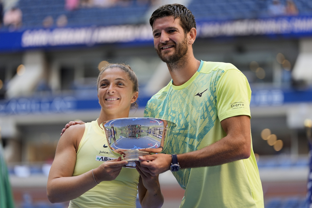 FILE - Sara Errani, of Italy, and Andrea Vavassori, of Italy, hold up the championship trophy after defeating Taylor Townsend, of the United States, and Donald Young, of the United States, in the mixed doubles final of the U.S. Open tennis championships, Thursday, Sept. 5, 2024, in New York. (AP Photo/Julia Nikhinson, File)