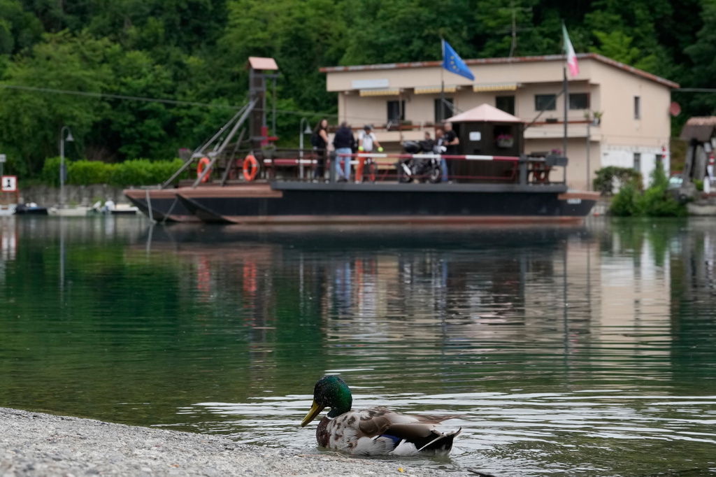 Commuters board the “Da Vinci Ferry,” a hand-operated ferry of a type sketched by Leonardo da Vinci in the 15th century, on the Adda River between the provinces of Lecco and Bergamo, in Imbersago, Italy, Thursday, June 4, 2026. (AP Photo/Luca Bruno)