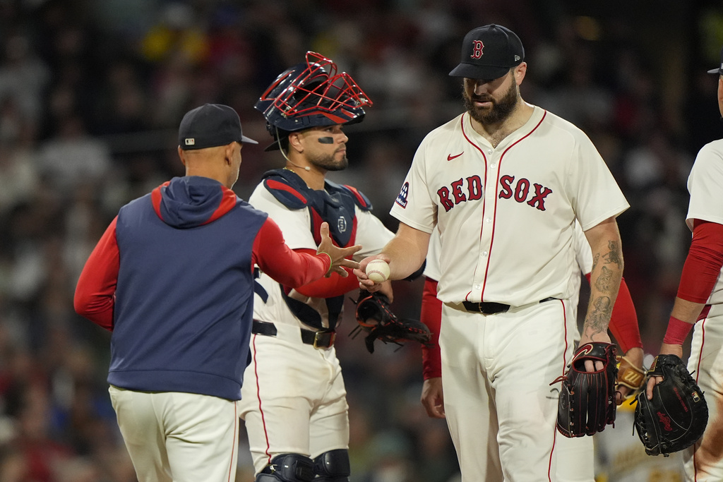Boston Red Sox starting pitcher Lucas Giolito hands over the ball after being pulled in the fifth inning of a baseball game against the Athletics, Wednesday, Sept. 17, 2025, in Boston. (AP Photo/Robert F. Bukaty)