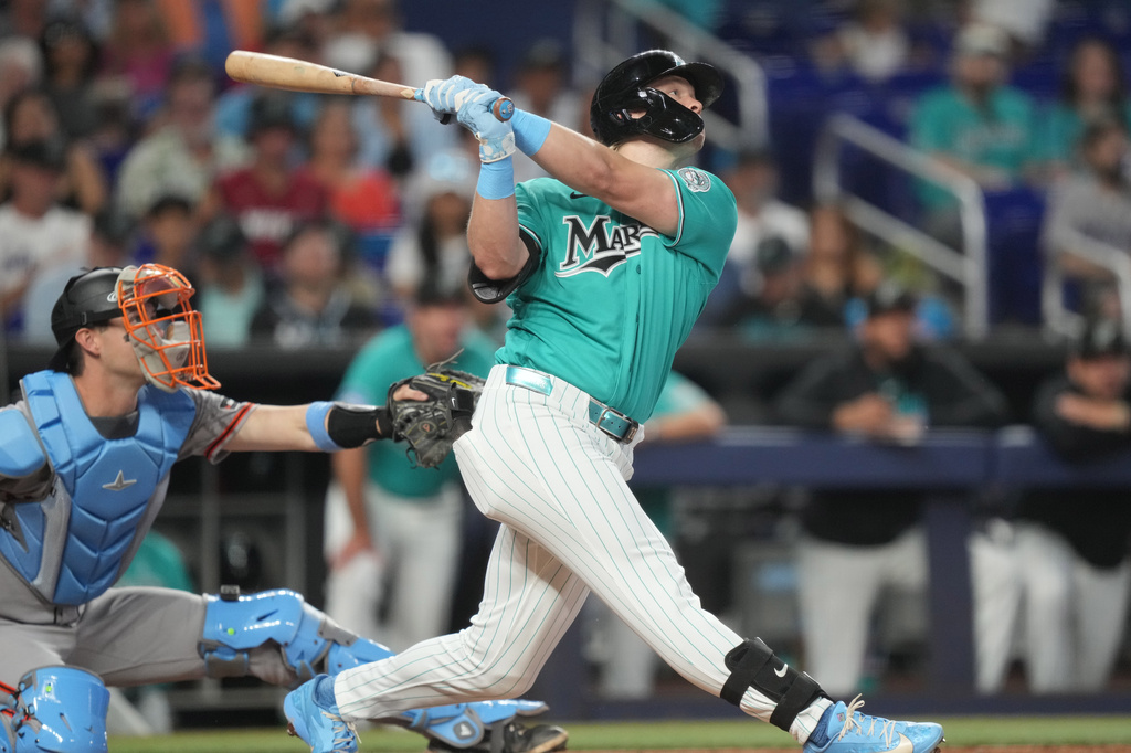 Miami Marlins' Kyle Stowers, right, hits a home run during the second inning of a baseball game against the San Francisco Giants, Sunday, June 21, 2026, in Miami. (AP Photo/Jim Rassol)