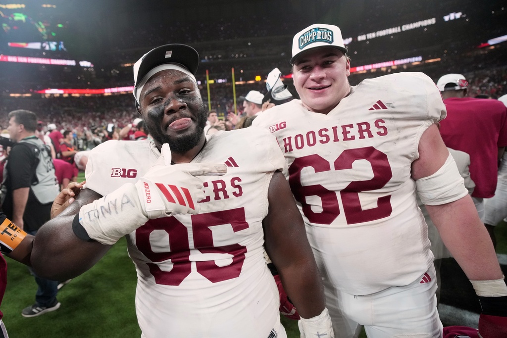 Indiana's Tyrique Tucker and Drew Evans celebrate after the Big Ten championship NCAA college football game against Ohio State in Indianapolis, Saturday, Dec. 6, 2025. (AP Photo/AJ Mast)