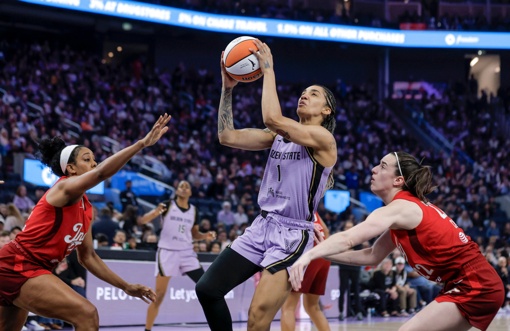 Golden State Valkyries' Gabby Williams (1) drives to basket between Indiana Fevers' Monique Billings (25) and Caitlin Clark (22) during the first half of a WNBA basketball game in San Francisco on Thursday, May 28, 2026. (Carlos Avila Gonzalez/San Francisco Chronicle via AP)