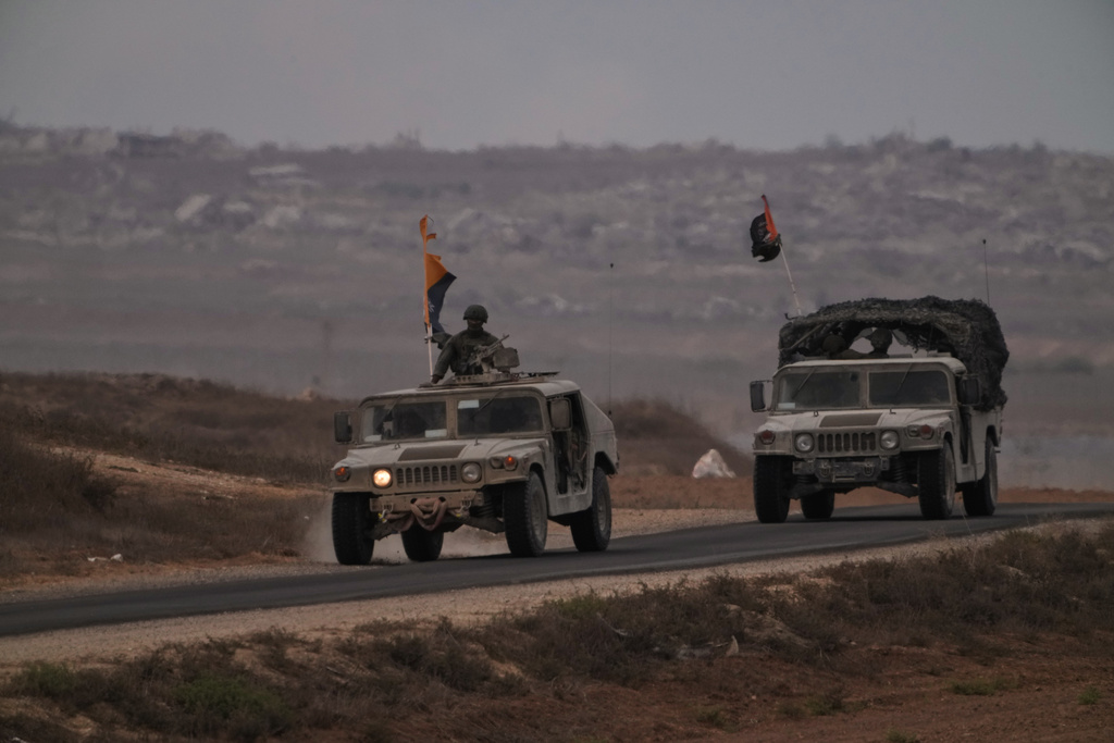 Israeli soldiers move near the Israeli-Gaza border, as seen from southern Israel, Thursday, Oct. 9, 2025, following the announcement that Israel and Hamas have agreed to the first phase of a peace plan to pause the fighting. (AP Photo/Ariel Schalit)