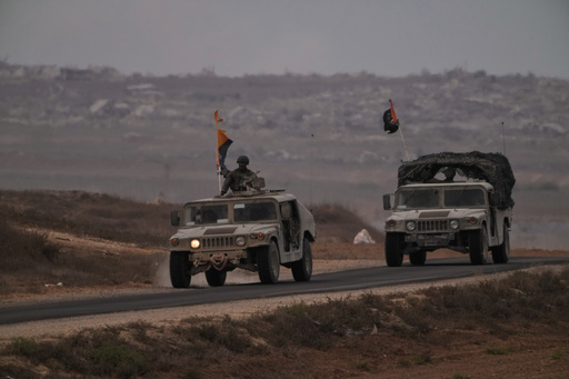 Israeli soldiers move near the Israeli-Gaza border, as seen from southern Israel, Thursday, Oct. 9, 2025, following the announcement that Israel and Hamas have agreed to the first phase of a peace plan to pause the fighting. (AP Photo/Ariel Schalit) Israeli soldiers move near the Israeli-Gaza border, as seen from southern Israel, Thursday, Oct. 9, 2025, following the announcement that Israel and Hamas have agreed to the first phase of a peace plan to pause the fighting. (AP Photo/Ariel Schalit)
