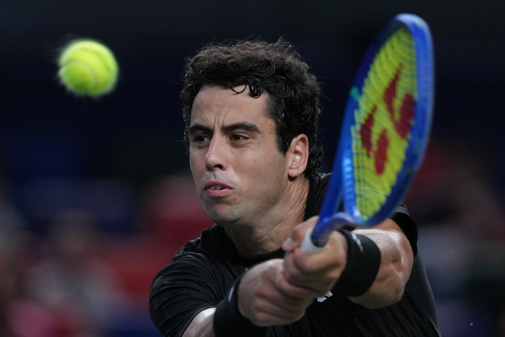 Jaume Munar, of Spain plays a backhand return to Novak Djokovic, of Serbia during the men's singles match of the Shanghai Masters tennis tournament at Qizhong Forest Sports City Tennis Center, in Shanghai, China, Tuesday, Oct. 7, 2025. (AP Photo/Andy Wong)