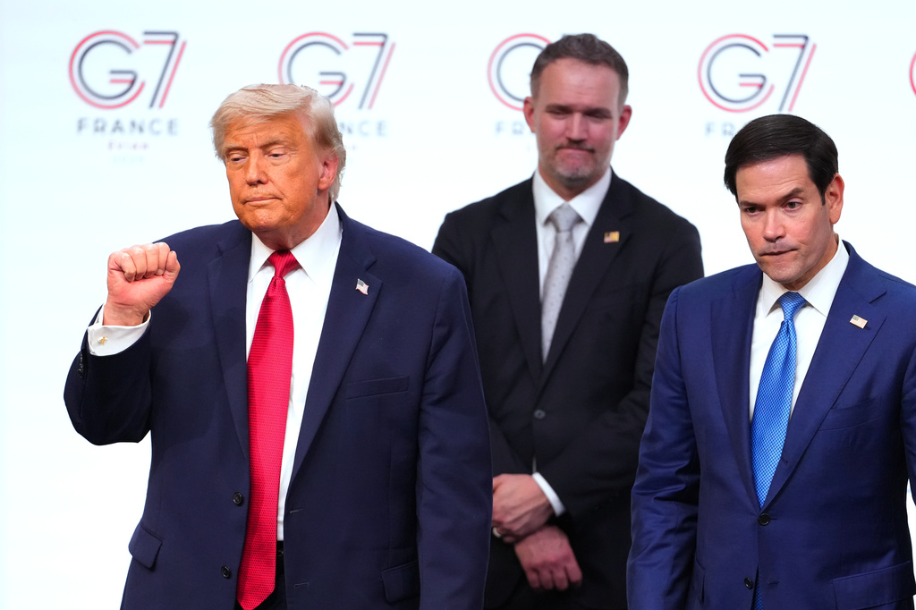 U.S. President Donald Trump, left, leaves the stage with, from right, United States Secretary of State Marco Rubio and U.S Trade Representative Jamieson Greer after a media conference at the end of the G7 summit in Evian-les-Bains, France, Wednesday, June 17, 2026. (AP Photo/Vadim Ghirda)