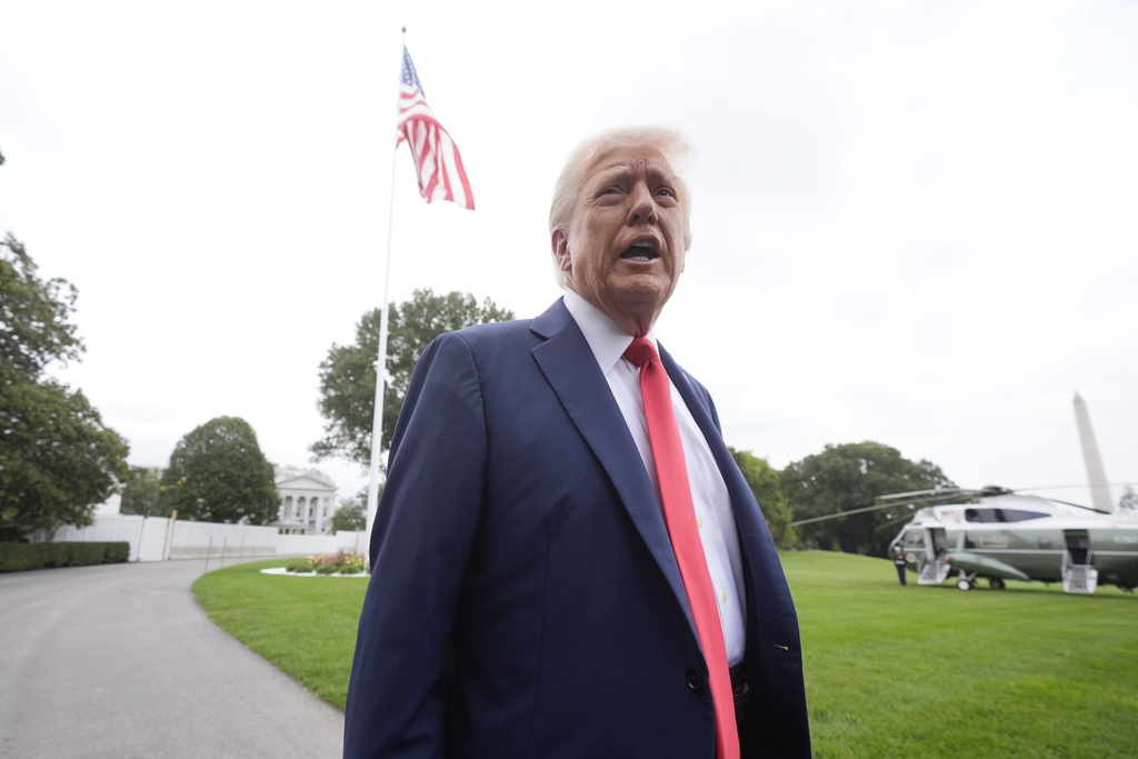 President Donald Trump speaking to members of the media on the South Lawn of the White House before boarding Marine One en route to Joint Base Andrews, Md., Sunday, Sept. 21, 2025, in Washington. (AP Photo/Mark Schiefelbein)