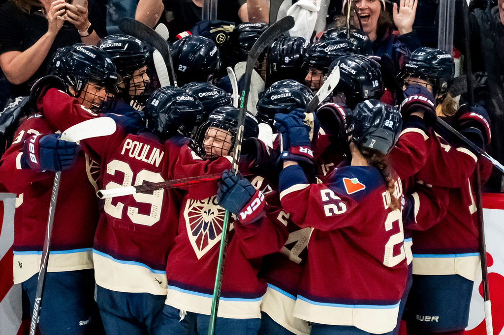 Montreal Victoire players celebrate after Maggie Flaherty (91) scored scored the game winning goal against Ottawa Charge during overtime in Game 2 of the PWHL Walter Cup finals hockey series in Laval, Quebec, Saturday, May 16, 2026.(Christopher Katsarov/The Canadian Press via AP)