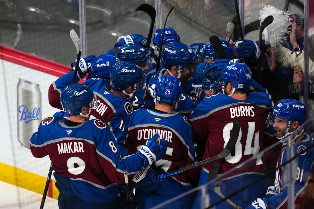 Colorado Avalanche center Nicolas Roy (10) is congratulated by teammates after scoring the game winning goal against the Los Angeles Kings in overtime of Game 2 in the first round of the NHL hockey Stanley Cup playoffs, Tuesday, April 21, 2026, in Denver. (AP Photo/Jack Dempsey)
