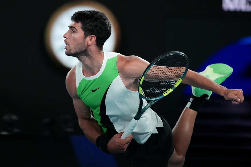 Carlos Alcaraz of Spain serves to Alex de Minaur of Australia during their quarterfinal match at the Australian Open tennis championship in Melbourne, Australia, Tuesday, Jan. 27, 2026. (AP Photo/Aaron Favila)