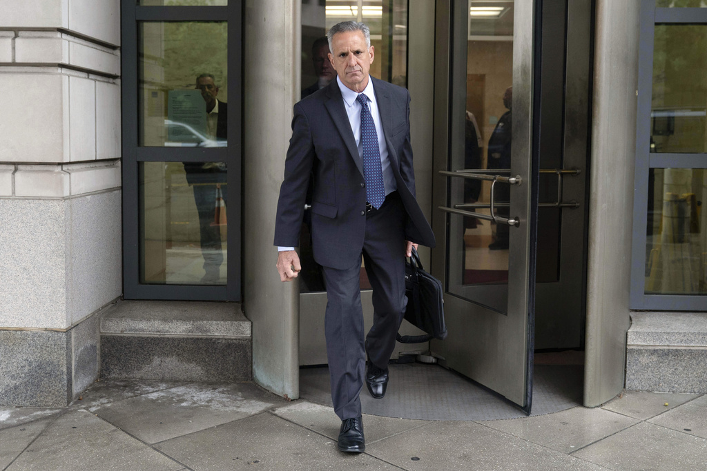 Retired Adm. Robert P. Burke, 63, walks out of the federal courthouse after being sentenced to six year in prison for his conviction on corruption charges, Tuesday, Sept. 16, 2025, in Washington. (AP Photo/Jose Luis Magana)