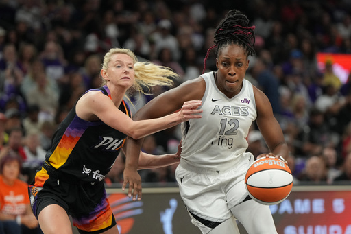 Las Vegas Aces guard Chelsea Gray (12) drives past Phoenix Mercury guard Lexi Held, left, during the first half of Game 4 of the WNBA basketball finals, Friday, Oct. 10, 2025, in Phoenix. (AP Photo/Rick Scuteri) Las Vegas Aces guard Chelsea Gray (12) drives past Phoenix Mercury guard Lexi Held, left, during the first half of Game 4 of the WNBA basketball finals, Friday, Oct. 10, 2025, in Phoenix. (AP Photo/Rick Scuteri)