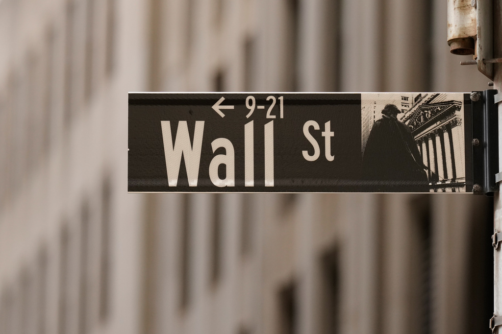 FILE - A Wall Street sign is seen outside of the New York Stock Exchange in New York, Monday, March 30, 2026. (AP Photo/Seth Wenig, File)