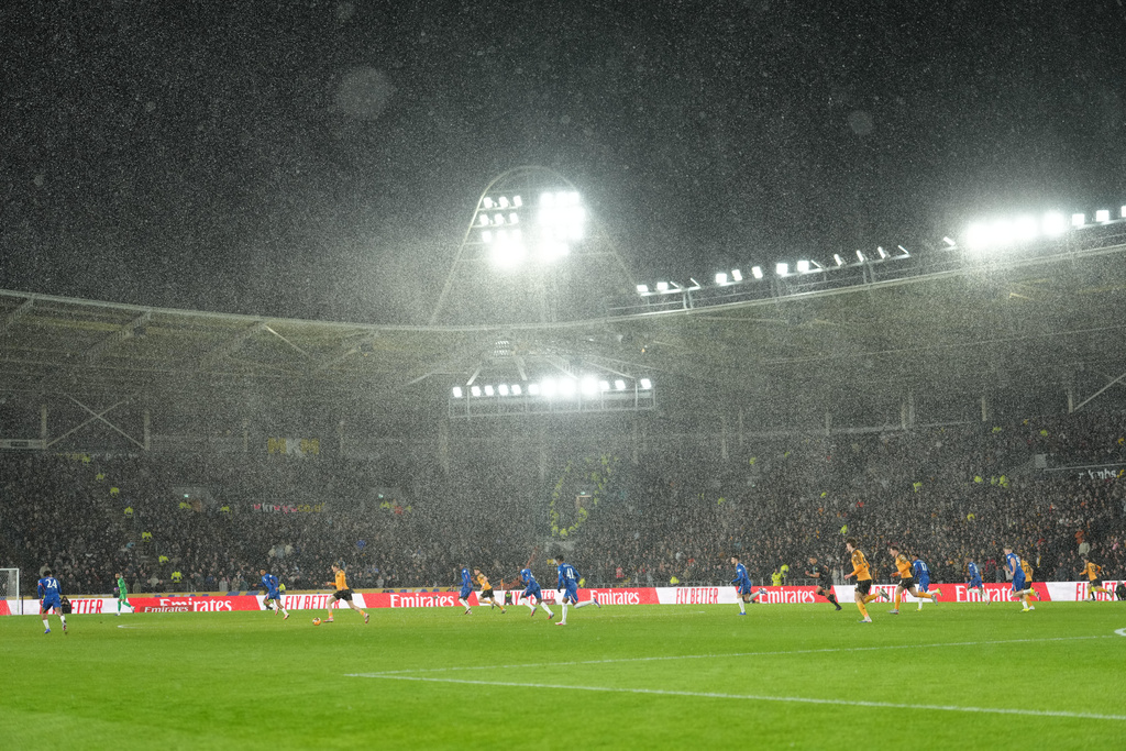 A heavy rain falls during the English FA Cup fourth round soccer match between Hull City and Chelsea in Hull, England, Friday, Feb. 13, 2026. (AP Photo/Jon Super)