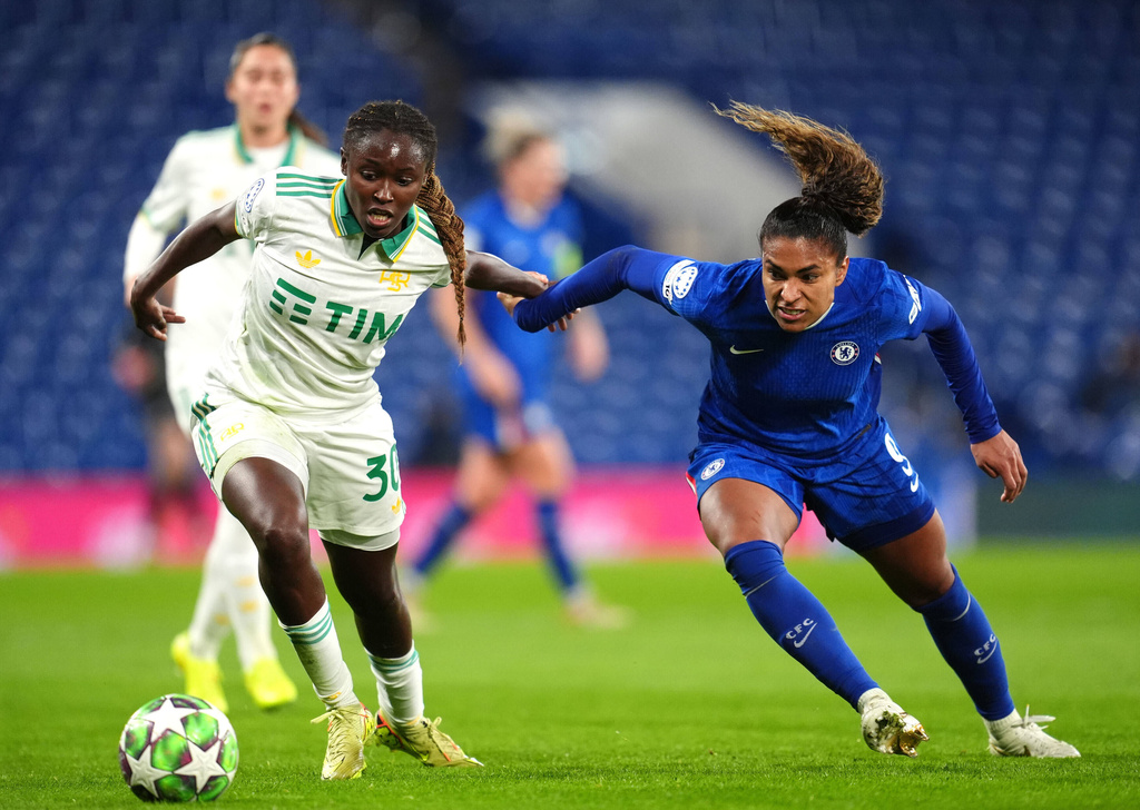 Roma's Omorinsola Babajide, left, and Chelsea's Catarina Macario in action during the Women's Champions League soccer match between Chelsea and Roma at Stamford Bridge, London, Wednesday Dec. 10, 2025. (Adam Davy/PA via AP)