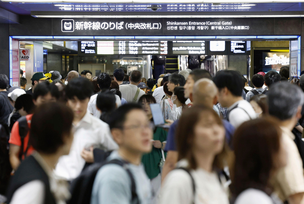 People crowd at Hakata station as bullet train services are suspended due to heavy rain, in Hakata, Fukuoka prefecture, southern Japan Monday, Aug. 11, 2025. (Takumi Sato/Kyodo News via AP)