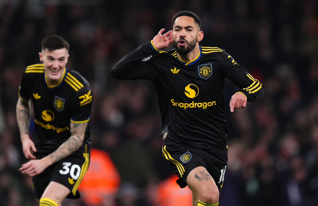 Manchester United's Matheus Cunha celebrates scoring their side's third goal of the game during the English Premier League soccer match between Arsenal and Manchester United in London, Sunday, Jan. 25, 2026. (Mike Egerton/PA via AP)