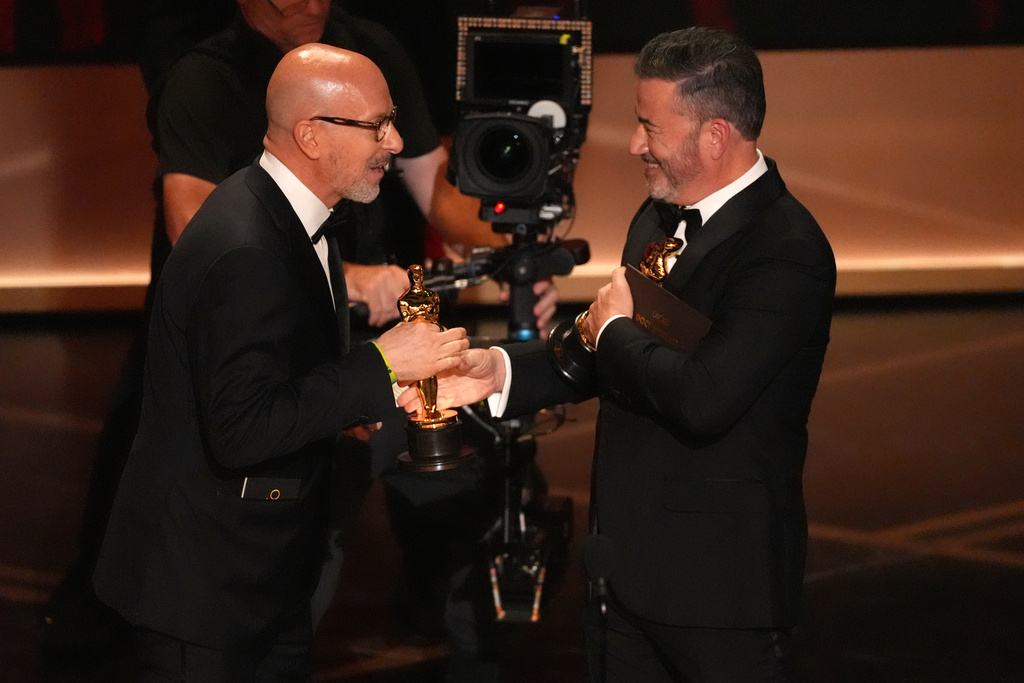 Jimmy Kimmel, right, presents the award for best documentary short film to Joshua Seftel for "All the Empty Rooms" during the Oscars on Sunday, March 15, 2026, at the Dolby Theatre in Los Angeles. (AP Photo/Chris Pizzello)