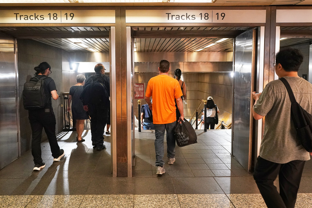 Passengers walk to Long Island Rail Road trains in Pennsylvania Station, in New York, Tuesday, May 19, 2026. (AP Photo/Richard Drew)