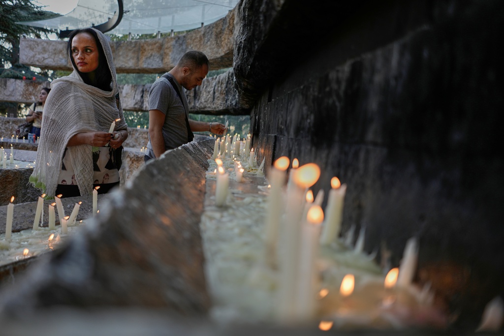 Pilgrims light candles at the Our Lady of Lebanon shrine in Harissa, east of Beirut, Lebanon, Sunday, Nov. 9, 2025. (AP Photo/Hassan Ammar)