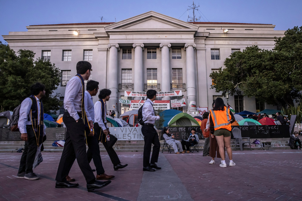 FILE - Students in graduation garb walk by a pro-Palestinian tent encampment on the steps of Sproul Hall at University of California, Berkeley in Berkeley, Calif., on May 2, 2024. (Carlos Avila Gonzalez/San Francisco Chronicle via AP, File)