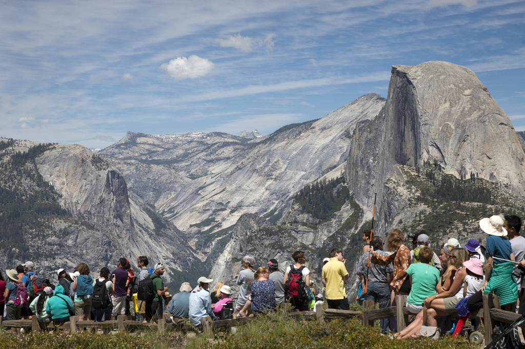FILE - People wait for the trailhead at Glacier Point to re-open at Yosemite National Park, Calif., June 18, 2016. (AP Photo/Jacquelyn Martin, File)