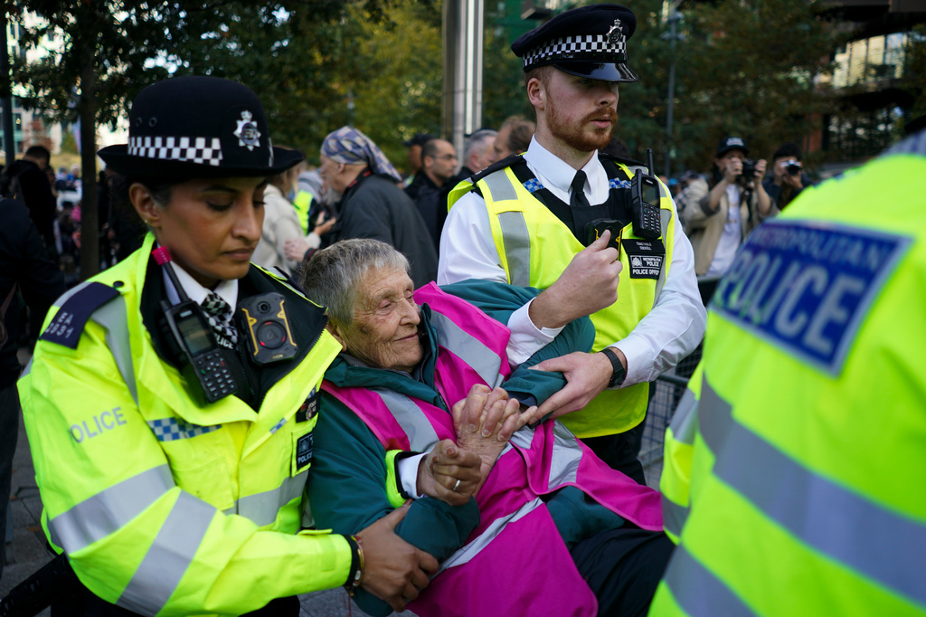 Police officers arrest a protester during a demonstration in support of Palestine Action, outside the US embassy, in London, Saturday, Oct. 31, 2026. (AP Photo/Alberto Pezzali)