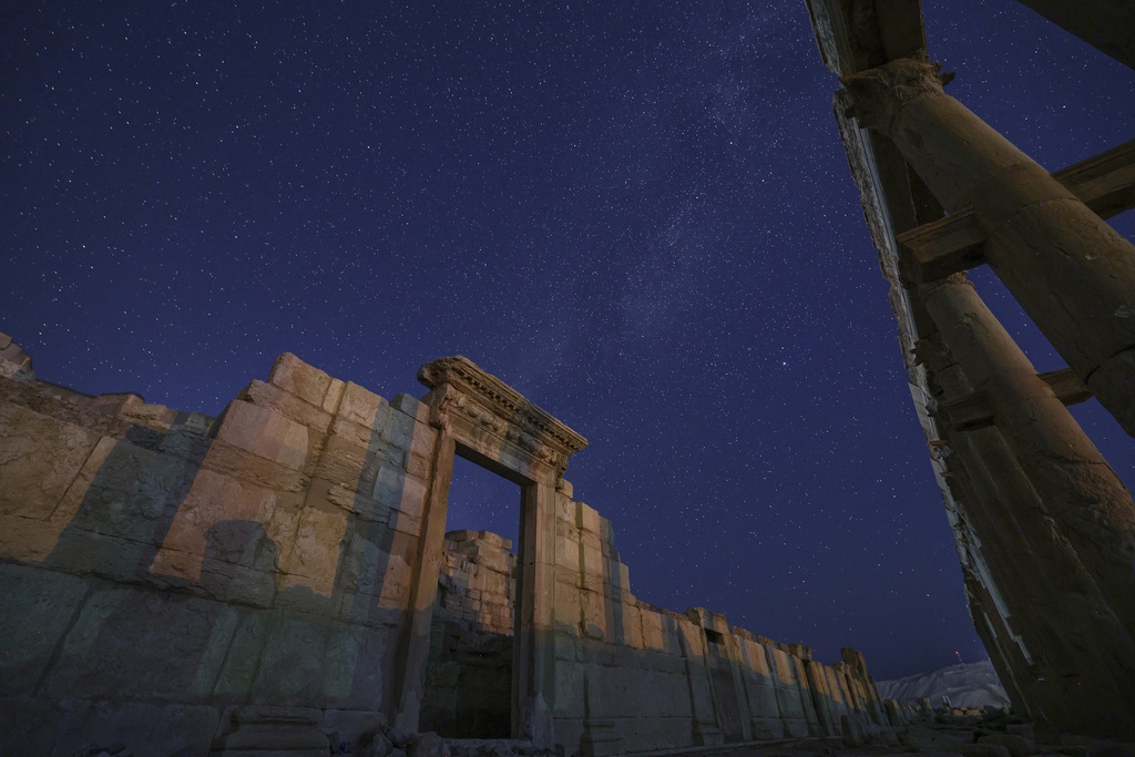 The rear gate of the Roman Theater in the ancient city of Palmyra is seen under a star-studded sky in Syria, early Wednesday, Aug. 27, 2025. (AP Photo/Ghaith Alsayed)