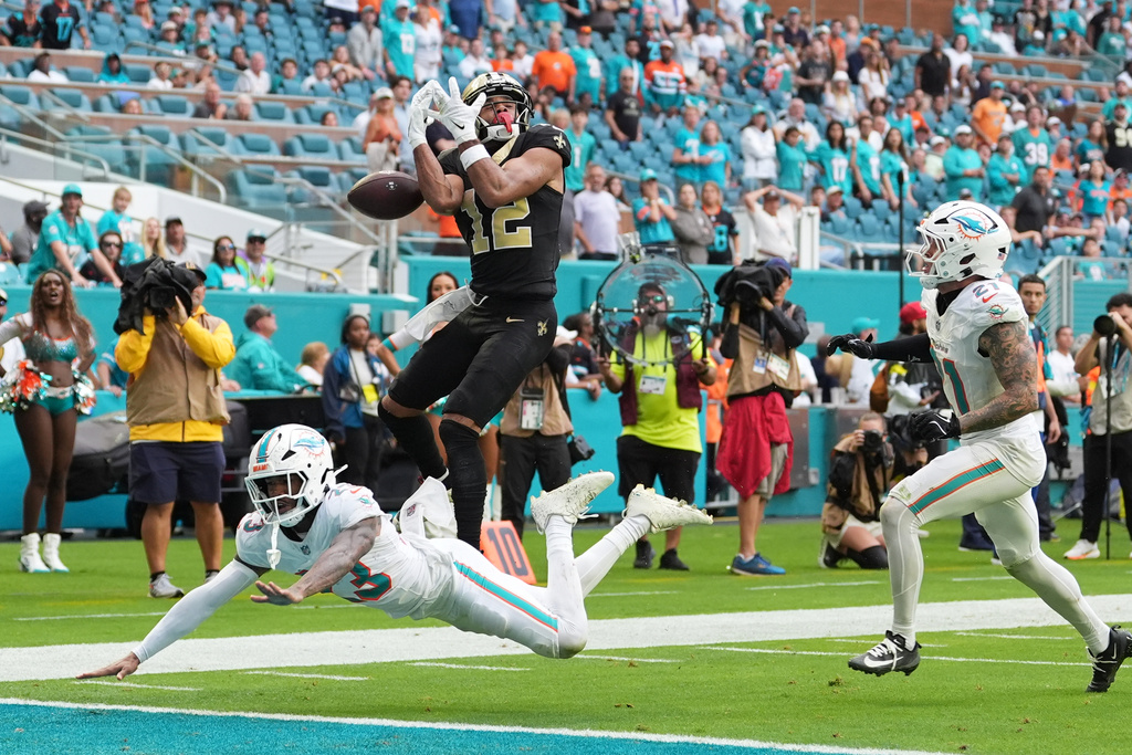 New Orleans Saints wide receiver Chris Olave (12) is unable to catch a pass during the second half of an NFL football game against the Miami Dolphins Sunday, Nov. 30, 2025, in Miami Gardens, Fla. (AP Photo/Rebecca Blackwell)