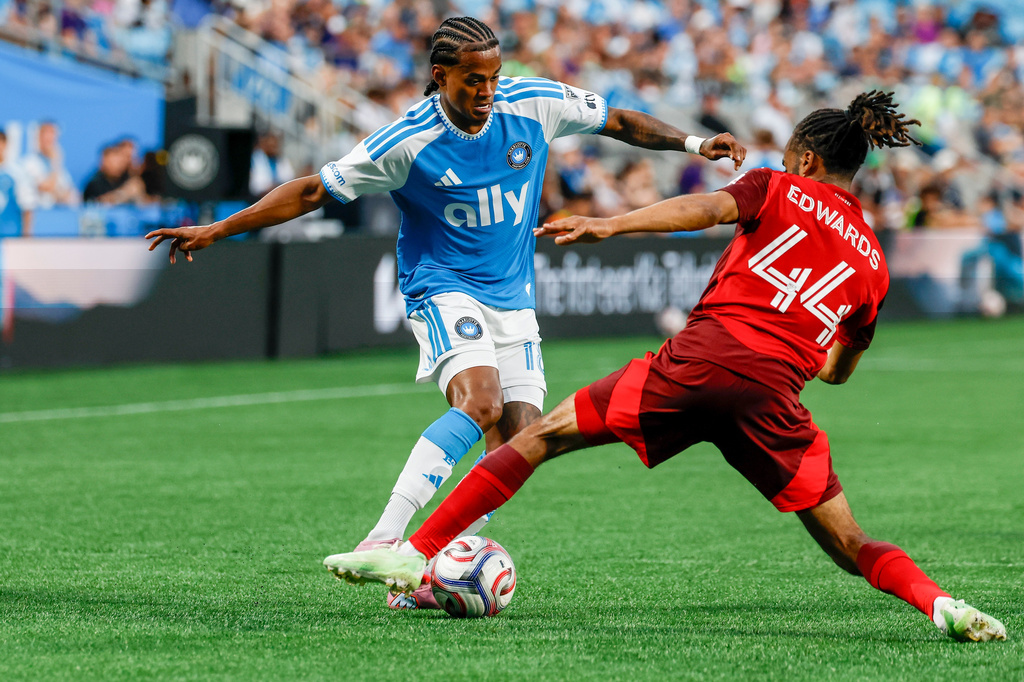 Charlotte FC forward Kerwin Vargas, left, moves the ball against Toronto FC defender Raheem Edwards (44) during the first half of an MLS soccer match in Charlotte, N.C., Saturday, May 16, 2026. (AP Photo/Nell Redmond)