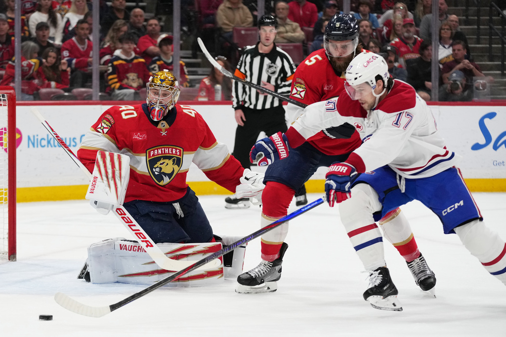 Florida Panthers goaltender Daniil Tarasov (40) and defenseman Aaron Ekblad (5) defend against Montréal Canadiens right wing Josh Anderson (17) during the first period of an NHL hockey game, Tuesday, Dec. 30, 2025, in Sunrise, Fla. (AP Photo/Lynne Sladky)