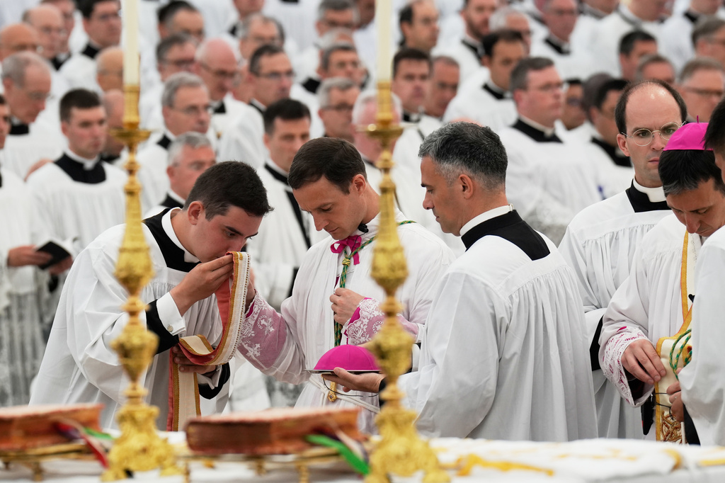 Father Marc Hanappier, center, attends his consecration ceremony as bishop in a tent set up outside the Society of St. Pius X seminary, in Econe, Switzerland, Wednesday, July 1, 2026. (AP Photo/Baz Ratner)