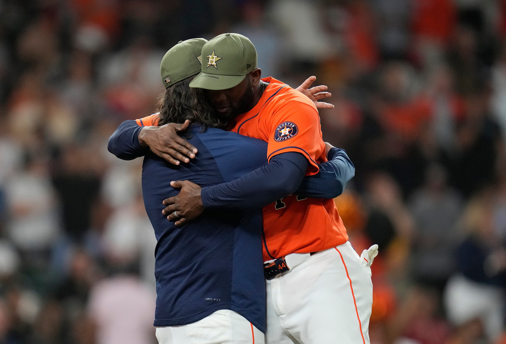Houston Astros starting pitcher Spencer Arrighetti, left, celebrates with Yordan Alvarez after a baseball game against the Texas Rangers, Friday, May 15, 2026, in Houston. (AP Photo/Karen Warren)