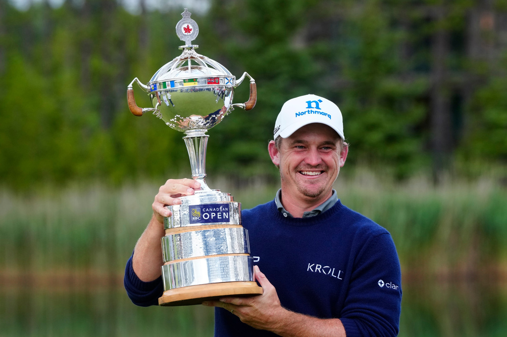 Bud Cauley, of the United States, poses with the trophy after winning the Canadian Open golf tournament in Caledon, Ontario, Sunday June 14, 2026. (Frank Gunn/The Canadian Press via AP)