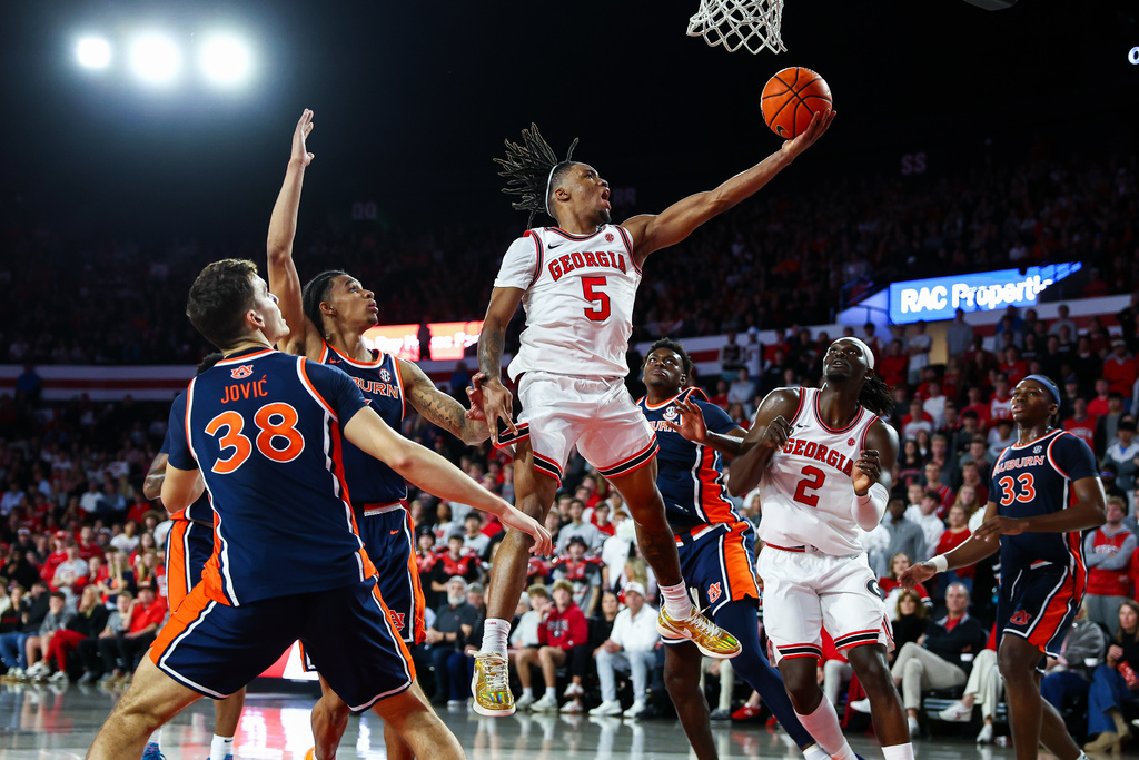 Georgia guard Jeremiah Wilkinson (5) shoots against Auburn forward Filip Jovic (38) during the first half of an NCAA college basketball game, Saturday, Jan. 3, 2026, in Athens, Ga. (AP Photo/Colin Hubbard)