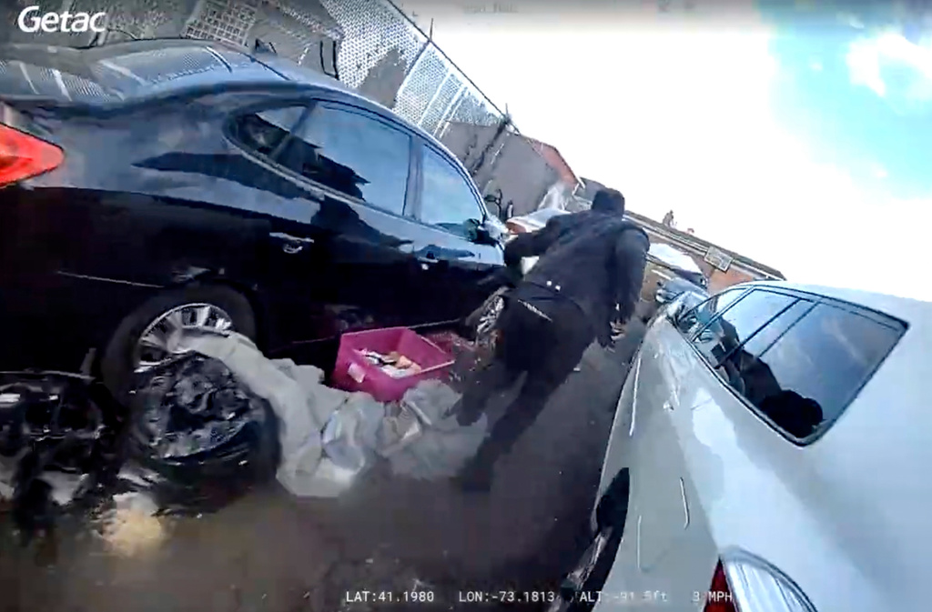 In this photo taken from video released by the Bridgeport Police Department, Dyshan Best runs from a Bridgeport Police officer while holding a gun Monday, March 31, 2025, in Bridgeport, Conn. (Bridgeport Police Department via AP)