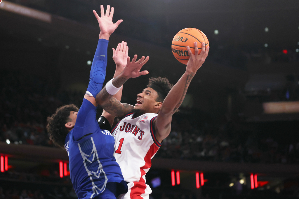 St. John's forward Dillon Mitchell (1) goes up for a shot over Creighton forward Jasen Green during the second half of an NCAA college basketball game, Saturday, Feb. 21, 2026, in New York. (AP Photo/Heather Khalifa)