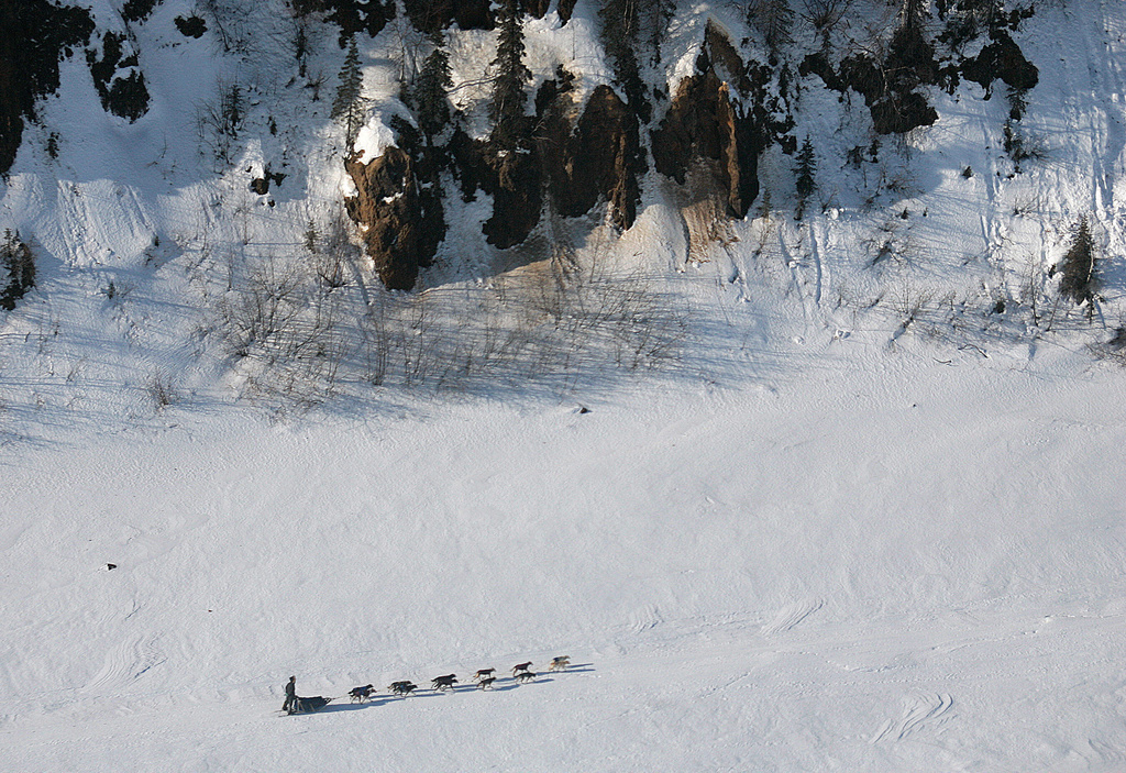 FILE - Ryan Redington of Knik, Alaska, grandson of Joe Redington Sr., the father of the Iditarod, drives his team on the Yukon River past the bluffs near Grayling, Alaska, on the Iditarod Trail Sled Dog Race, March 10, 2007. (AP Photo/Al Grillo)