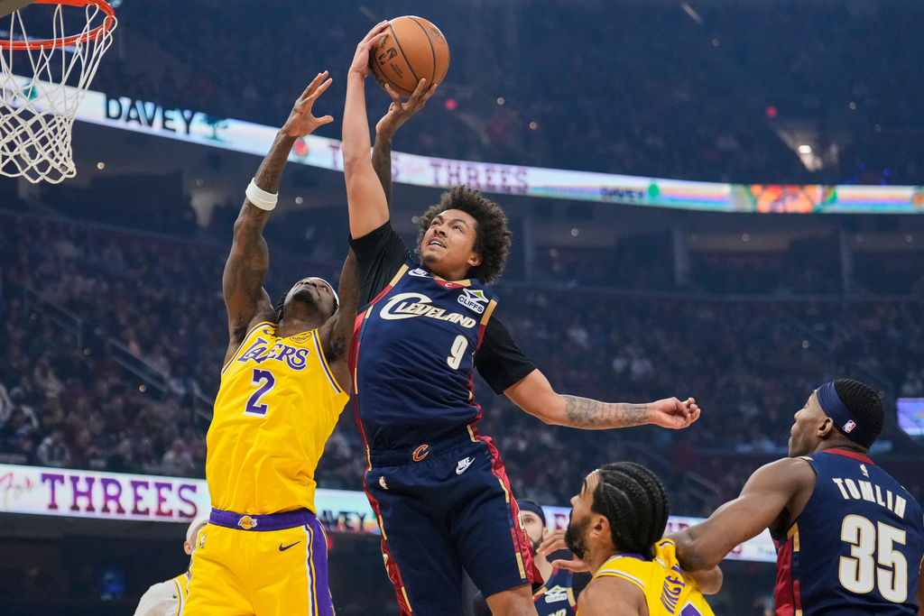 Los Angeles Lakers forward Jarred Vanderbilt (2) and Los Angeles Lakers guard Bronny James (9) reach for a rebound in the first half of an NBA basketball game in Cleveland, Wednesday, Jan. 28, 2026. (AP Photo/Sue Ogrocki)