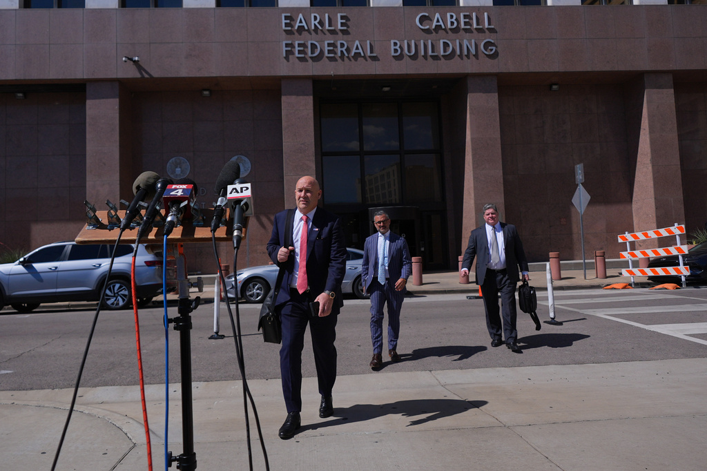 FILE - Attorney Bradford Cohen, left, walks over to speak to reporters with fellow lawyers Saam Zangeneh, left, and John Helms after a detention hearing in Federal Court for their client rapper Pooh Shiesty, whose legal name is Lontrell Williams Jr. in Dallas, April 8, 2026. (AP Photo/LM Otero, File)