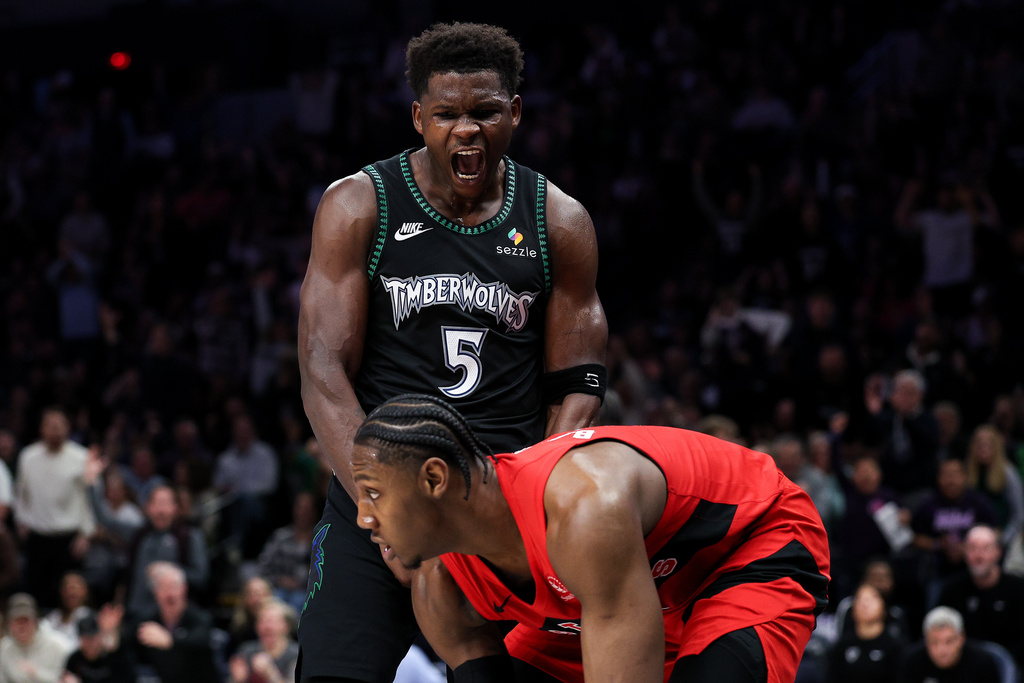 Minnesota Timberwolves guard Anthony Edwards (5) celebrates his dunk in front of Toronto Raptors forward RJ Barrett (9) during the second half of an NBA basketball game Thursday, March 5, 2026, in Minneapolis. (AP Photo/Matt Krohn)